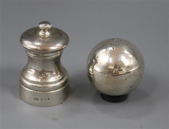 A silver pepper mill and a spherical silver salt